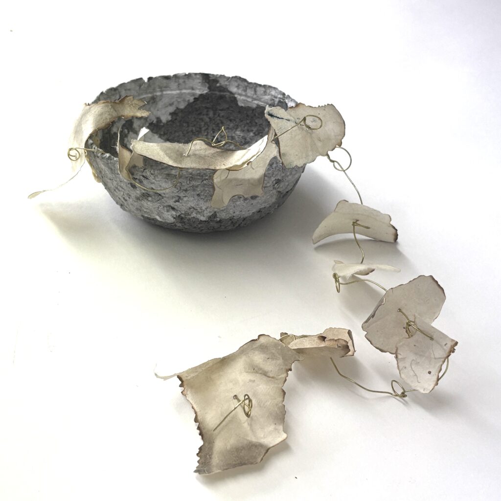 Paper maché bowl with burned paper on wire