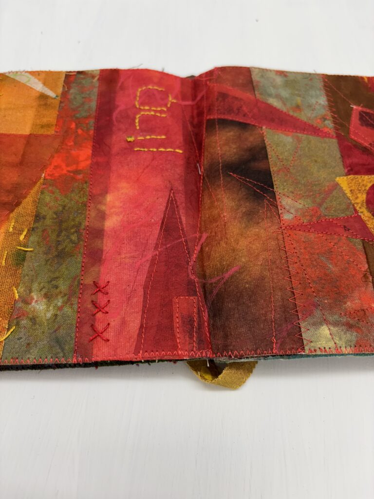 Fabric artist book with red collages pages and Jewish theme
